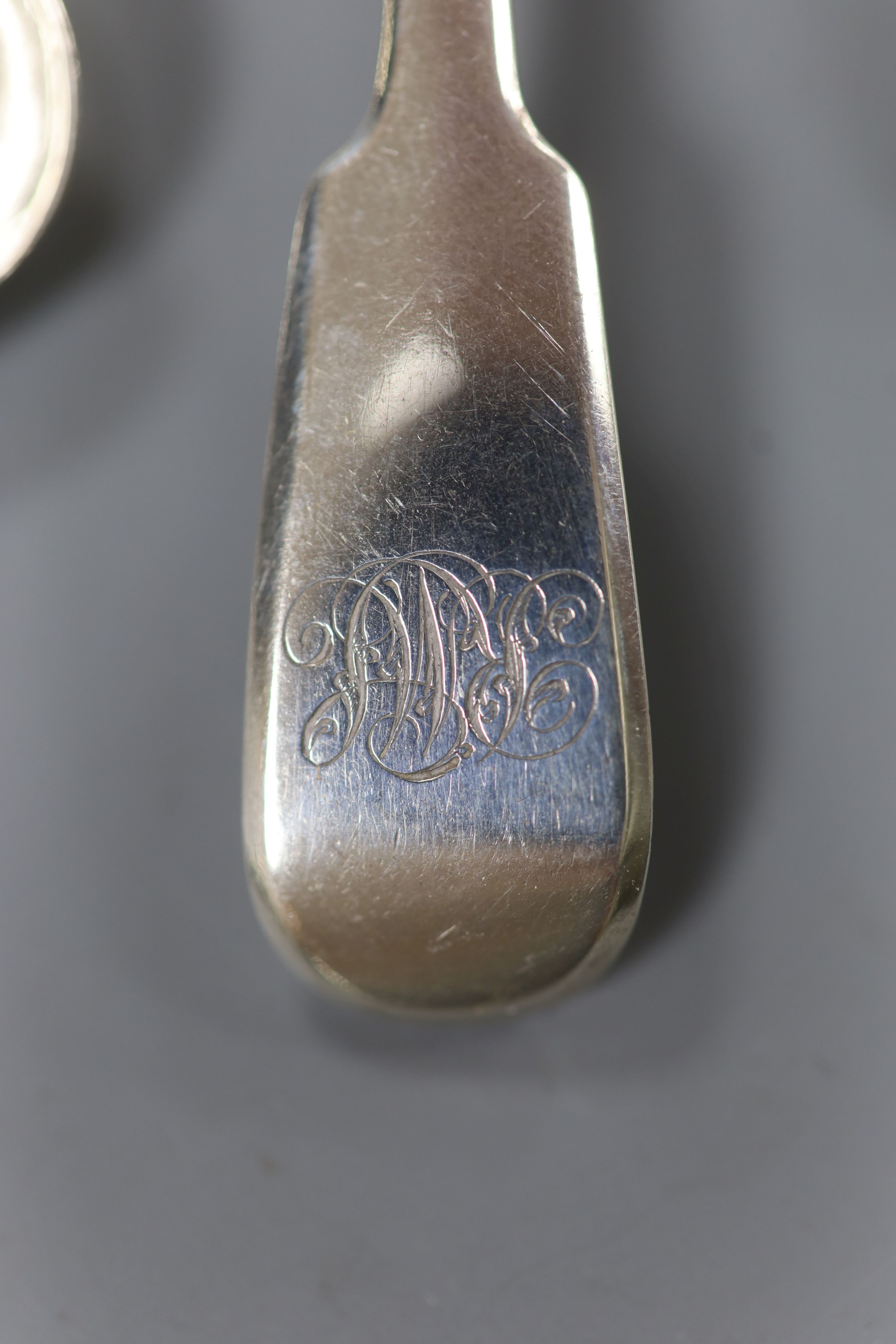 A pair of Mappin & Webb silver seal top spoons, five silver mustard spoons, four salts spoons, a pair of sugar tongs (Georgian and later) and a plated sauce ladle